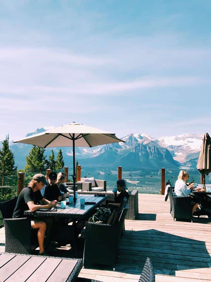 Family enjoys an outdoor lunch with a view of the mountains at Banff National Park