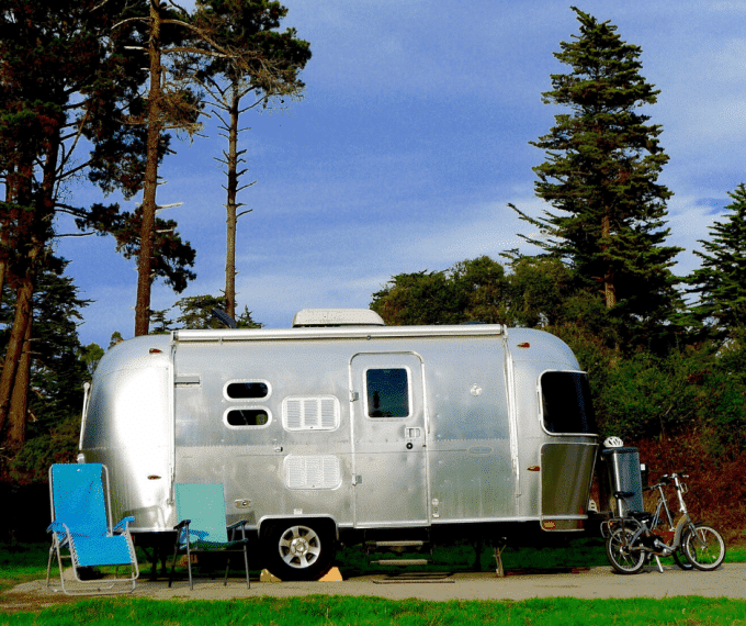 Airstream travel trailer with bikes and camping chairs
