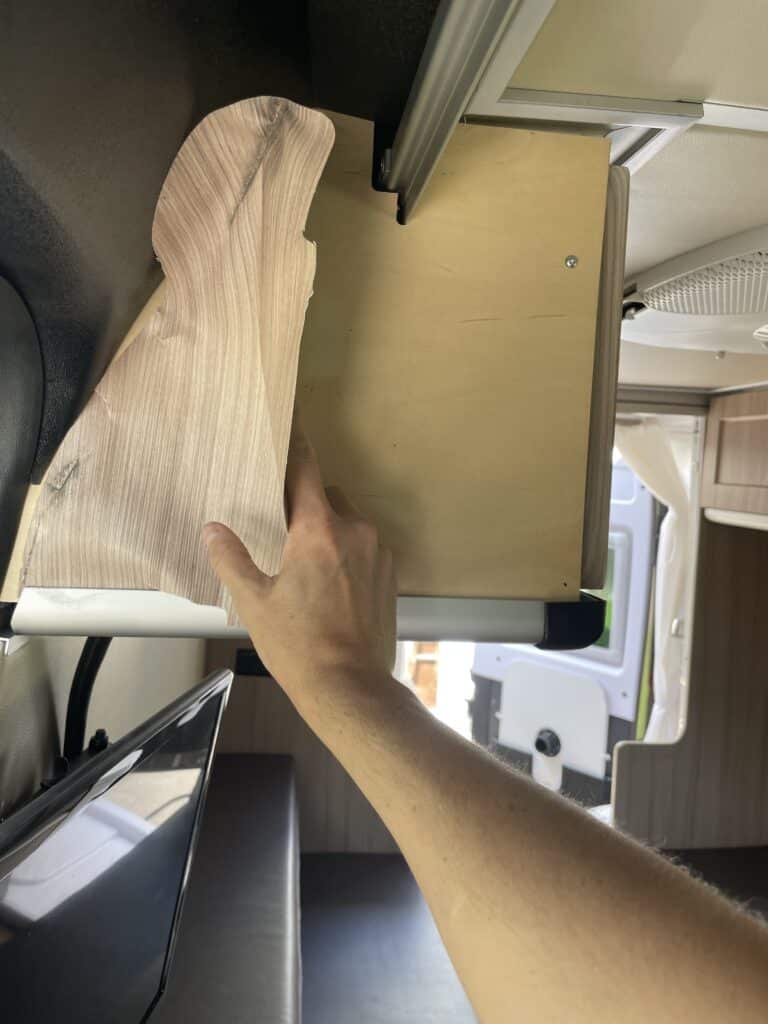 Man removing wall paper from camper van
