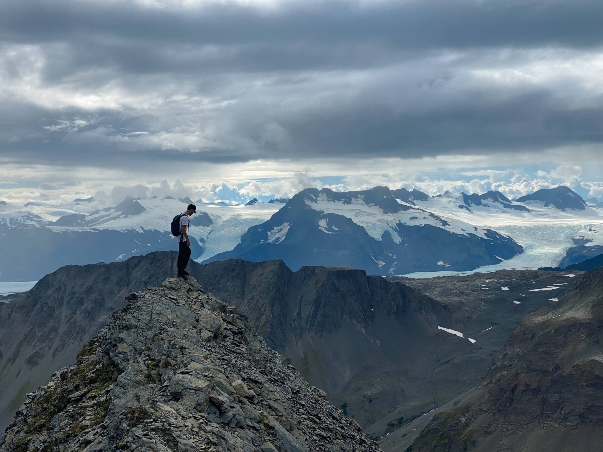 Man on mountain peak in Seward Alaska
