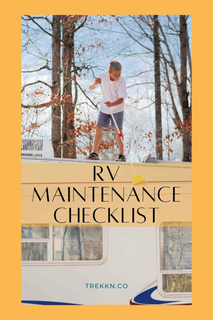 Young man on top of RV sweeping off debris as part of regular RV maintenance checklist.